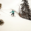A Female Snowboarder Lays Out Some